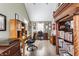 Well-appointed home office featuring custom bookshelves, ample desk space, and natural light from a window at 4451 N Washington Blvd, Indianapolis, IN 46205
