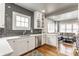 Modern kitchen features white cabinets, stainless steel appliances, stylish backsplash and hardwood floors at 4451 N Washington Blvd, Indianapolis, IN 46205