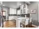 Bright kitchen features white cabinets, stainless steel appliances, breakfast bar and hardwood floors at 4451 N Washington Blvd, Indianapolis, IN 46205
