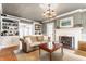 Cozy living room with a fireplace, built-in shelving, and ample seating at 4451 N Washington Blvd, Indianapolis, IN 46205