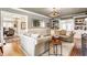Spacious living room with hardwood floors, a fireplace, and built-in bookshelves at 4451 N Washington Blvd, Indianapolis, IN 46205