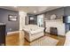 Spacious main bedroom features hardwood floors, fireplace, sitting area, and a view of the hallway at 4451 N Washington Blvd, Indianapolis, IN 46205
