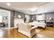 Large main bedroom with a sitting area, a fireplace, hardwood floors, and ample natural light at 4451 N Washington Blvd, Indianapolis, IN 46205