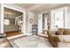 Sitting area featuring neutral paint, brick floor, a patterned chair and seamless access to other rooms at 4451 N Washington Blvd, Indianapolis, IN 46205