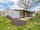 View of the backyard featuring a white exterior, covered patio and landscaping at 4897 Walker St, Greenwood, IN 46143