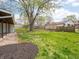 Spacious backyard featuring a large tree and lush green grass at 4897 Walker St, Greenwood, IN 46143