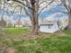 Backyard showing the shed, large trees, and a grass lawn at 4897 Walker St, Greenwood, IN 46143