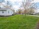 Spacious backyard featuring a well-maintained lawn with tidy mulch beds at 4897 Walker St, Greenwood, IN 46143