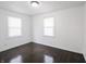 Sunlit bedroom with hardwood floors, neutral walls, and window blinds at 4897 Walker St, Greenwood, IN 46143