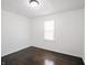 Bright bedroom featuring a window, dark wood flooring, and fresh white walls at 4897 Walker St, Greenwood, IN 46143