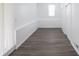 Hallway features paneled walls, hardwood floors, and natural light at 4897 Walker St, Greenwood, IN 46143