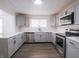 Contemporary kitchen featuring white countertops, gray cabinets, stainless steel appliances, and modern design at 4897 Walker St, Greenwood, IN 46143
