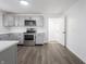 Modern kitchen with stainless steel appliances, gray cabinets and open layout to the dining area at 4897 Walker St, Greenwood, IN 46143