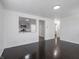 Open concept living room flows into the kitchen with stainless steel appliances and gray cabinets at 4897 Walker St, Greenwood, IN 46143