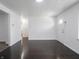 Bright living room with hardwood floors and white walls, complemented by a white entry door at 4897 Walker St, Greenwood, IN 46143