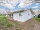 Backyard shed featuring an attached covered area, white siding, and landscaping at 4897 Walker St, Greenwood, IN 46143
