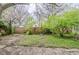 Lush backyard with mature trees and a chain link fence at 5017 E 14Th St, Indianapolis, IN 46201