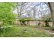 Lush backyard with mature trees and a chain link fence at 5017 E 14Th St, Indianapolis, IN 46201