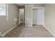 A carpeted bedroom with an open closet and a window lets in natural light at 5017 E 14Th St, Indianapolis, IN 46201