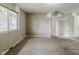 Neutral bedroom with wall repairs, carpet, an exterior window, and a hallway entryway at 5017 E 14Th St, Indianapolis, IN 46201