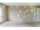 A spacious bedroom with a large window and carpeted flooring awaits new touches at 5017 E 14Th St, Indianapolis, IN 46201