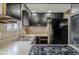 Outdated kitchen with black appliances, double sinks, and vintage tile backsplash and countertops at 5017 E 14Th St, Indianapolis, IN 46201