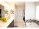 Bathroom with a double sink vanity, decorative plants, and warm lighting at 5051 Arling Ct, Indianapolis, IN 46237