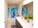 Well-lit bathroom featuring a double sink vanity and a vibrant Frozen-themed shower curtain at 5051 Arling Ct, Indianapolis, IN 46237