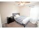 Cozy bedroom with a gray upholstered bed frame and a ceiling fan at 5051 Arling Ct, Indianapolis, IN 46237