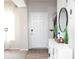 Hallway featuring wood flooring, the front door, and a view of staircase at 5051 Arling Ct, Indianapolis, IN 46237
