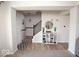 Hallway featuring wood flooring, an organizer with shoes, and view of staircase at 5051 Arling Ct, Indianapolis, IN 46237