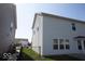 Side view of the property, showcasing the well-maintained vinyl siding and backyard features at 5051 Arling Ct, Indianapolis, IN 46237