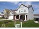 Charming home with a manicured lawn, featuring a two-car garage and covered front porch at 5051 Arling Ct, Indianapolis, IN 46237