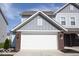 Close-up of the home's two-car garage, showcasing its brick accents and well-maintained exterior at 5051 Arling Ct, Indianapolis, IN 46237