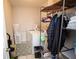 Functional laundry room with a washer, storage shelf, and stylish patterned rug on the floor at 5051 Arling Ct, Indianapolis, IN 46237