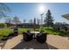 Backyard featuring a concrete patio set, grill, green grass and mature tree at 5124 Mccray St, Indianapolis, IN 46224