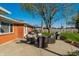 Backyard featuring a concrete patio set, grill, green grass and mature tree at 5124 Mccray St, Indianapolis, IN 46224