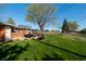 Spacious backyard featuring a concrete patio set, grill, green grass and mature tree at 5124 Mccray St, Indianapolis, IN 46224