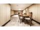 Finished basement area with wood paneled walls, tile floors, dining table and partial view of sitting area at 5124 Mccray St, Indianapolis, IN 46224