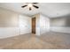 Carpeted bedroom featuring a ceiling fan, multiple closets, and neutral walls at 5124 Mccray St, Indianapolis, IN 46224