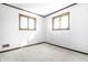 Bright bedroom with two windows, neutral carpet, clean walls, and wood trim throughout at 5124 Mccray St, Indianapolis, IN 46224