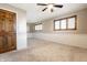Bedroom featuring neutral walls, carpet, wooden door, and natural light at 5124 Mccray St, Indianapolis, IN 46224