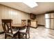 Dining area with a wooden table and chairs, a stainless steel refrigerator, and a kitchenette at 5124 Mccray St, Indianapolis, IN 46224
