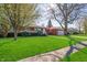 A well-maintained brick home with a lush green lawn and mature trees in a quiet neighborhood at 5124 Mccray St, Indianapolis, IN 46224