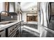 Modern kitchen with gray backsplash and cabinets, featuring stainless appliances and marble counters at 5124 Mccray St, Indianapolis, IN 46224