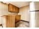Functional kitchenette with a wooden breakfast bar, stainless steel refrigerator, and wooden cabinetry at 5124 Mccray St, Indianapolis, IN 46224