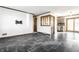 Spacious living room with tile floors, wood trim, and an open layout leading to the kitchen at 5124 Mccray St, Indianapolis, IN 46224