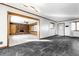 Open-concept living space with tile flooring flowing into a carpeted area featuring a brick fireplace at 5124 Mccray St, Indianapolis, IN 46224