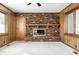 Bright living room boasting a brick fireplace with wooden mantel and large windows at 5124 Mccray St, Indianapolis, IN 46224