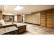Spacious living room featuring a sectional sofa, tiled floors, and access to other rooms at 5124 Mccray St, Indianapolis, IN 46224
